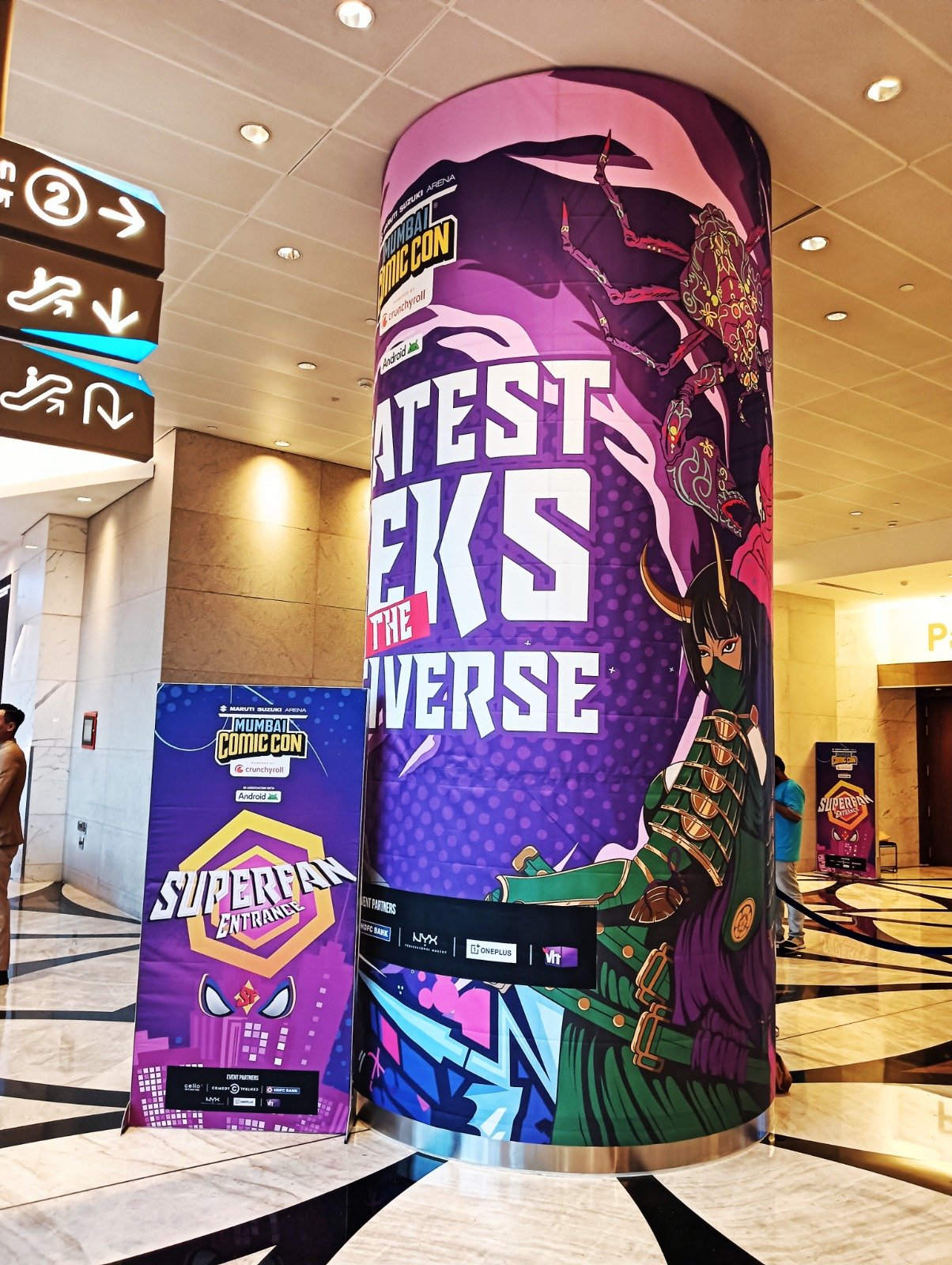 Pillar branding and standee graphics installed at a venue