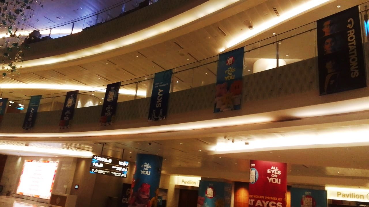 Suspended event branding banners in a venue atrium